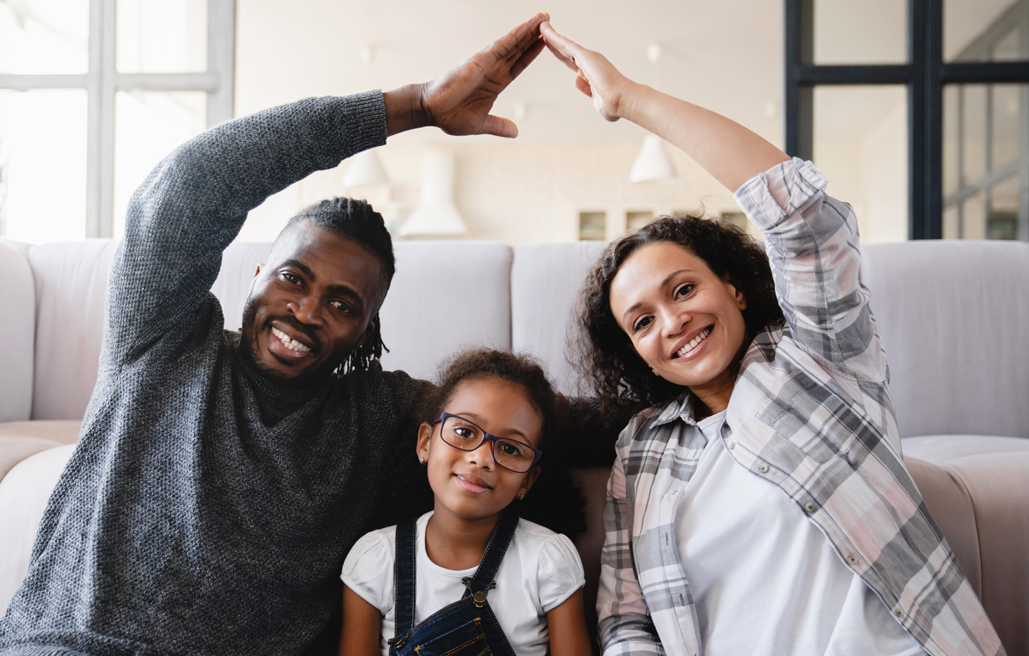 Portrait of cheerful multi ethnic business couple wearing suit and looking at camera with lot of copy space on right side